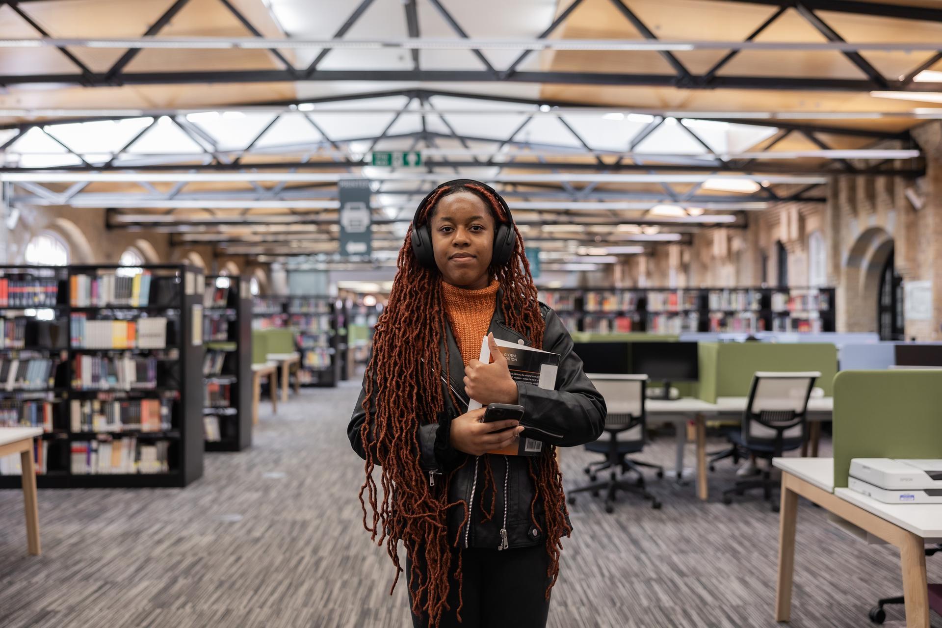 Student walking with books in hand
