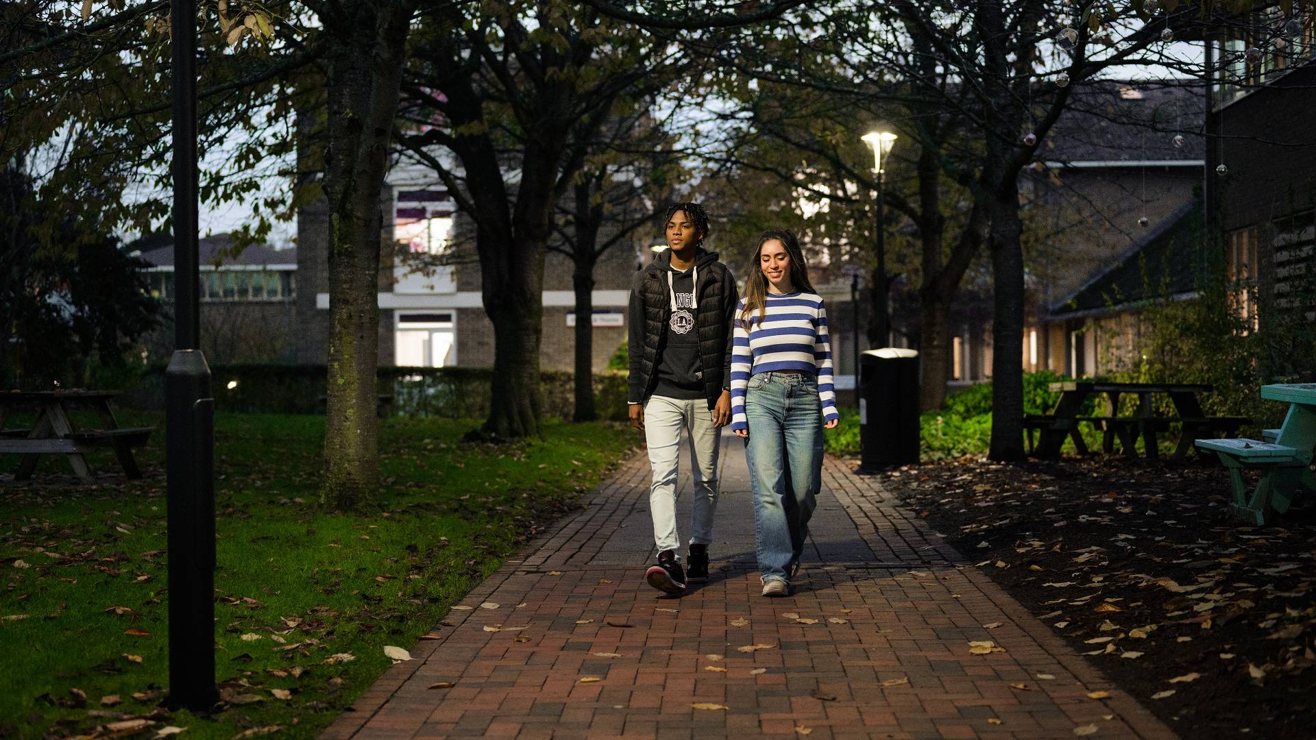 Two students walking through Canterbury campus